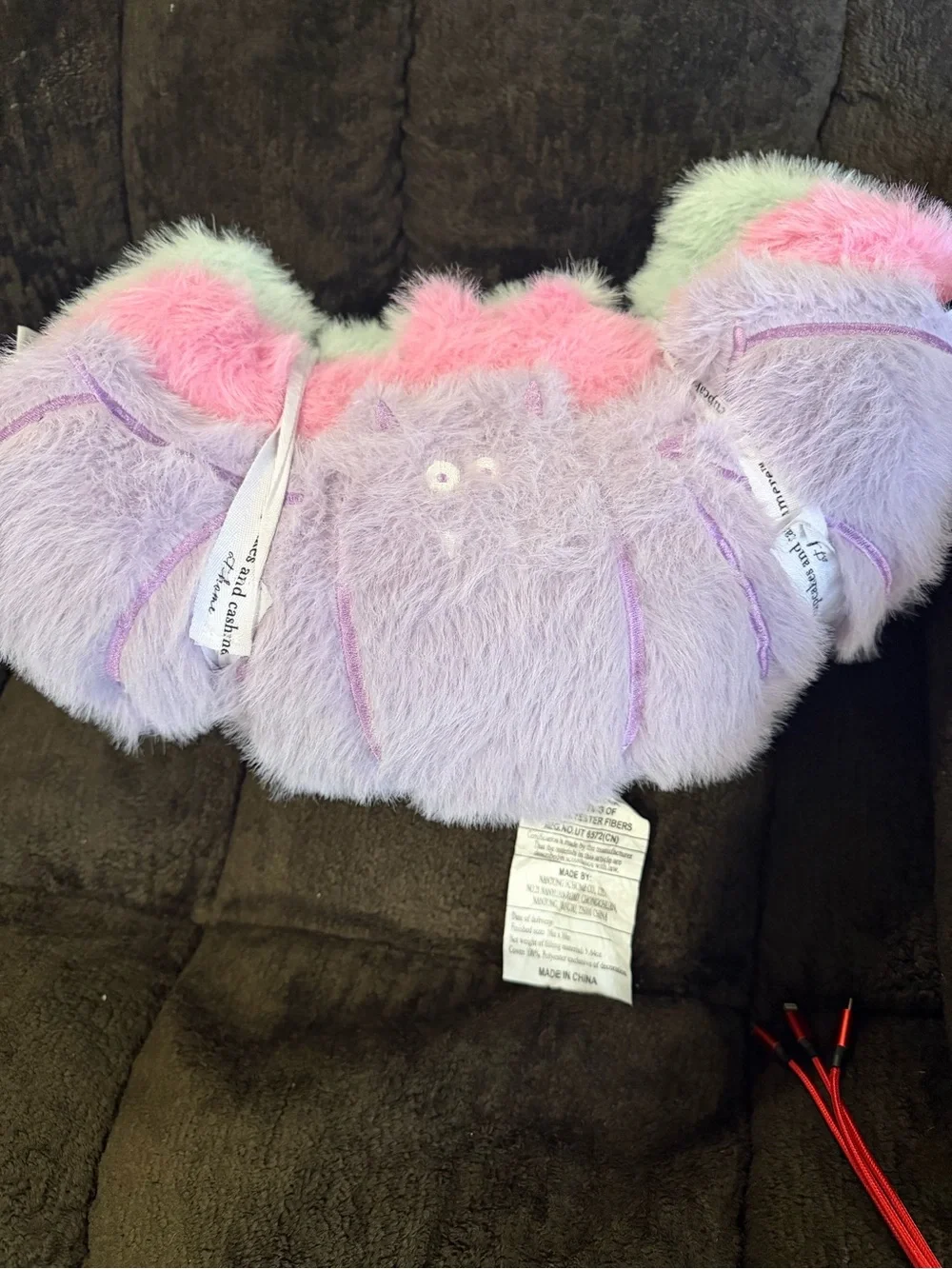 cupcakes & cashmere Pastel Fuzzy bat pillows in Pink, Lavender & Mint